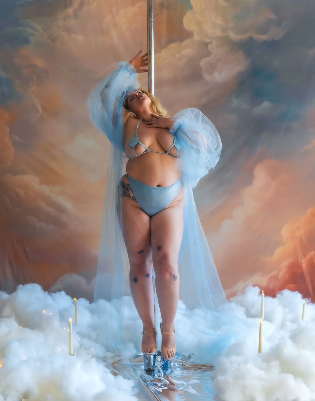 Person in a bikini standing on clouds with a fantasy sky background